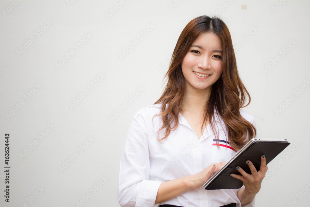 Portrait of thai adult working women white shirt using her tablet. Portrait of thai adult working women white shirt using her tablet.