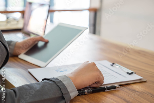 business digitaltablet and data on table with office photo