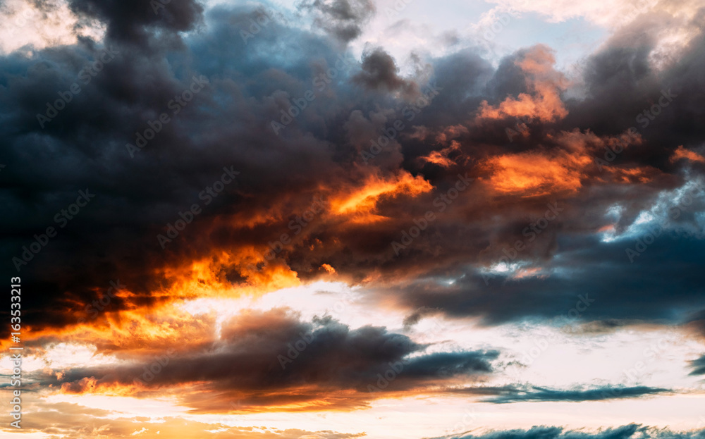 Fototapeta premium Dramatic gray, blue and orange sunset on beautiful sky, free space. Sky background on sunset with clouds