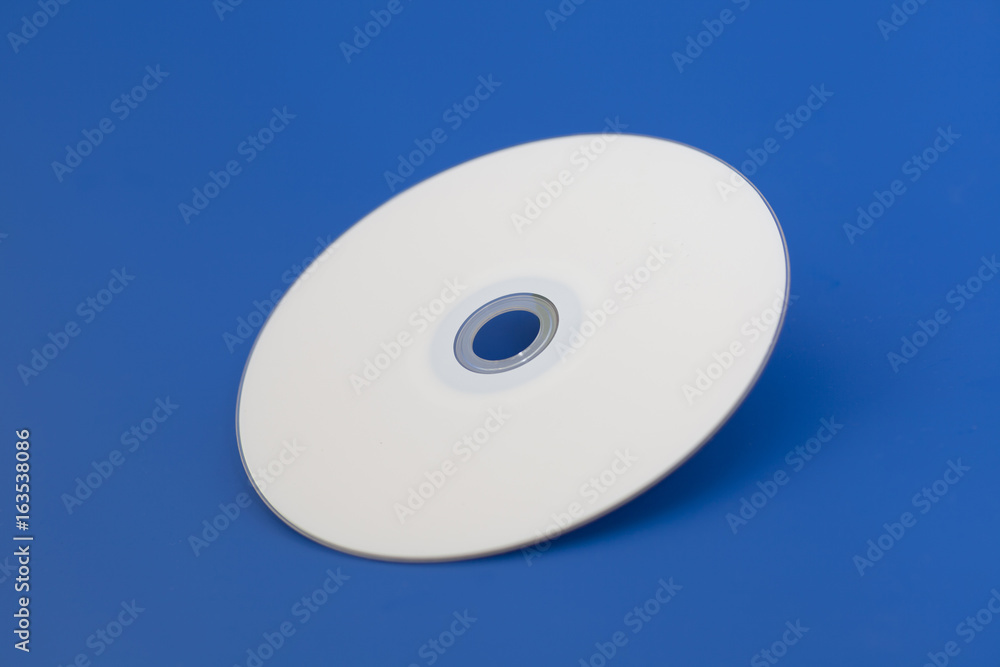 Compact Dvd Cd disk on blue background Compact Dvd Cd disk on blue background