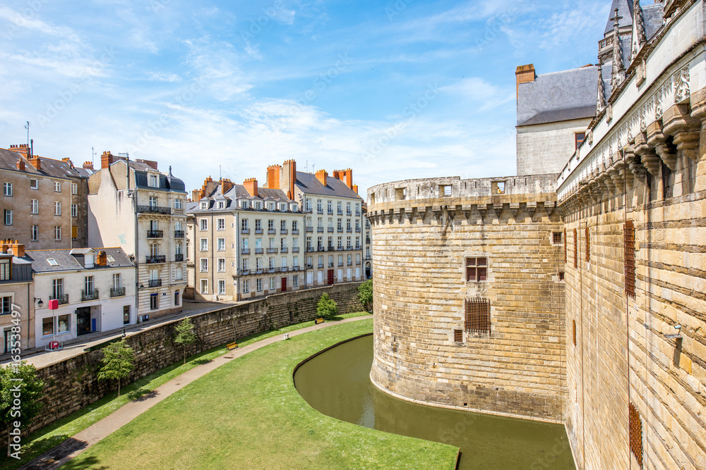 City scape view with castle wall and beautiful buildings in Nantes city during the sunny weather in France
