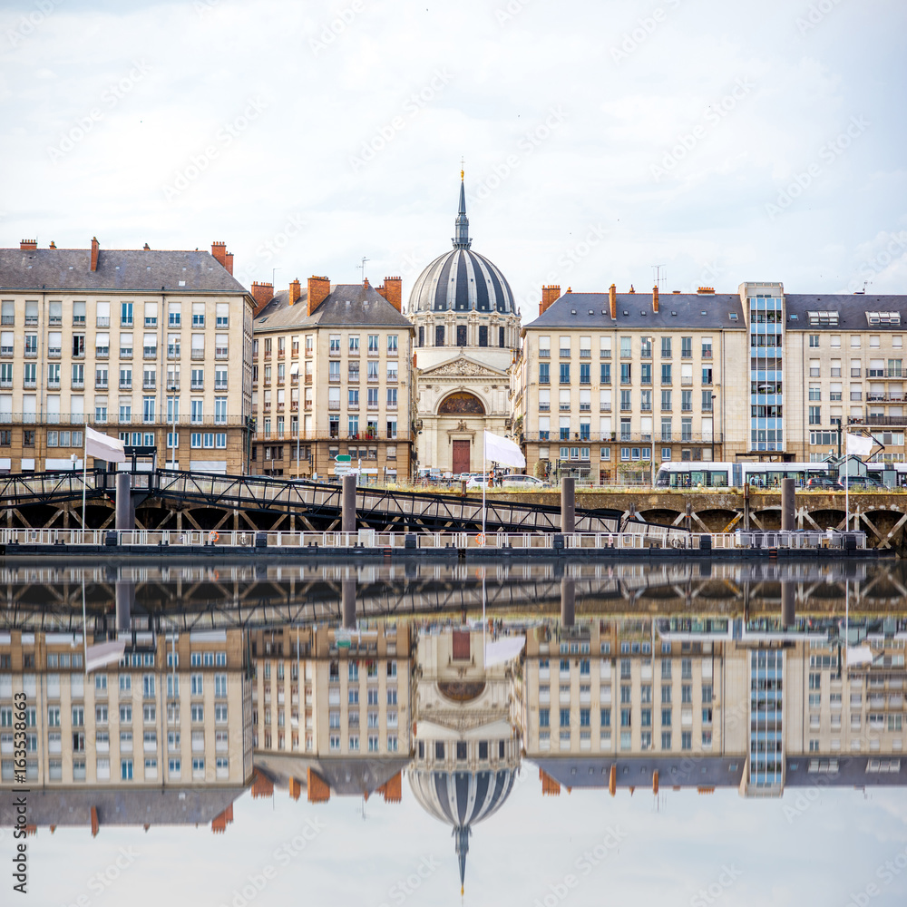 Beautiful riverside view with old buildings and Notre Dame cathedral in Nantes city in France