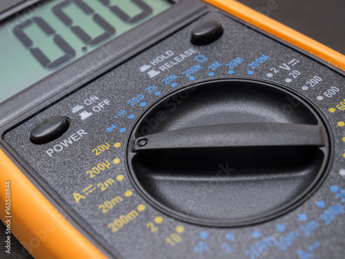 Multimeter and tester closeup on black background