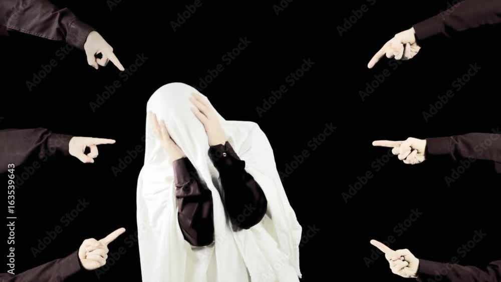 A man hiding under a blanket, desperately trying to avoid many hands