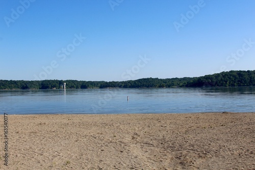 The view of the lake from the waters edge on the beach.
