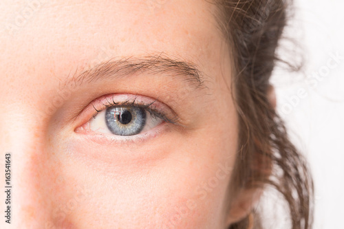 Fototapeta Naklejka Na Ścianę i Meble -  Close up of beautiful blue eye of young girl