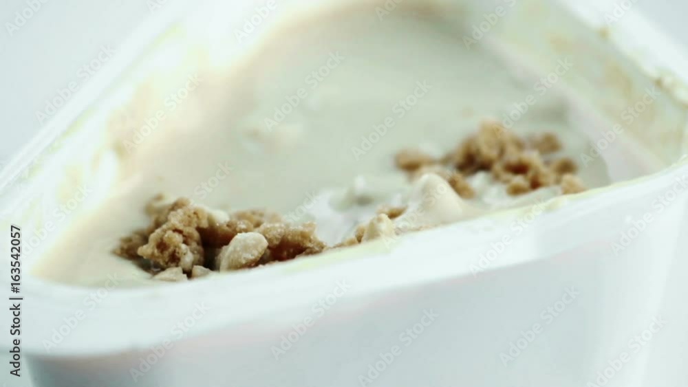 close-up of healthy cereal and chocolate on white yogurt and spoon, shot in slow motion , concept of healthy food nutrition