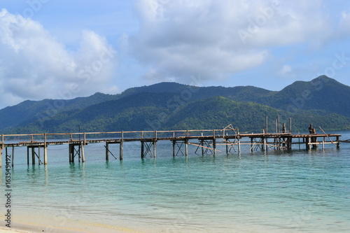 Wooden walkways stretching into the sea. Thailand © ALEX