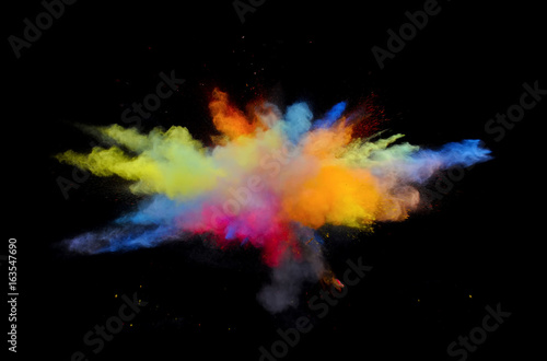 Multi color explosions of powder paint create abstract forms in front of a black background giving off fantastic colors formations.