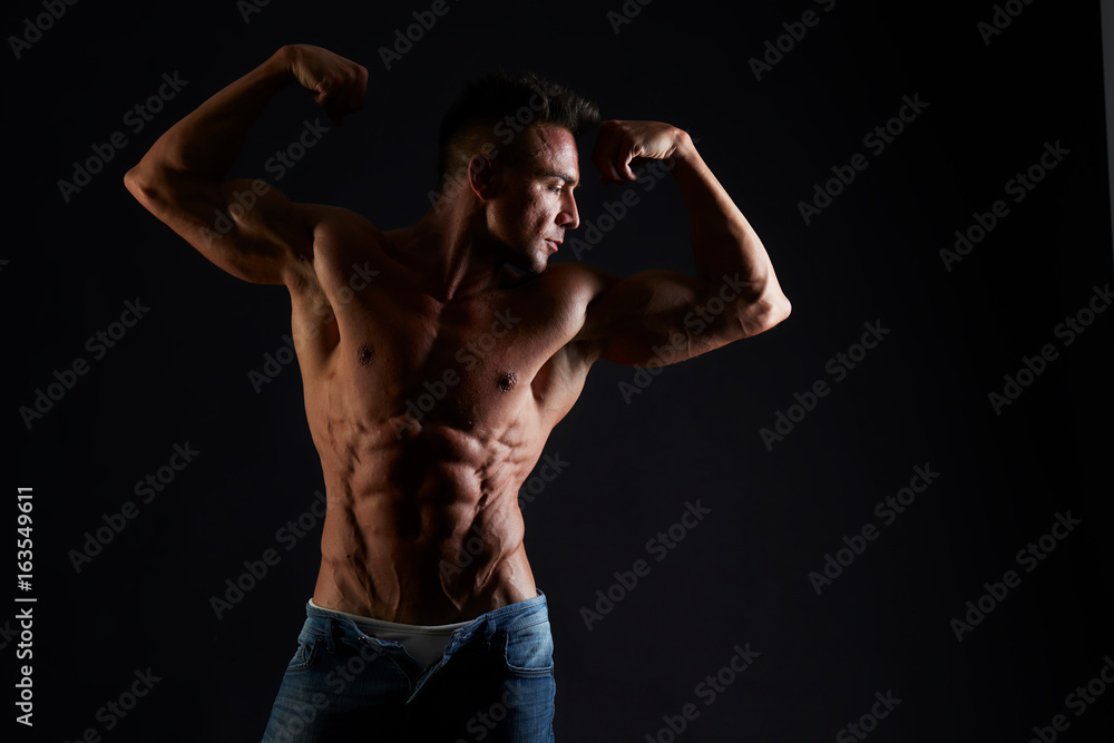 Handsome muscular fit young man on studio background Handsome muscular fit young man on studio background