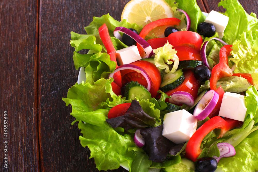 salad from fresh vegetables in a plate on a table, selective focus salad from fresh vegetables in a plate on a table, selective focus