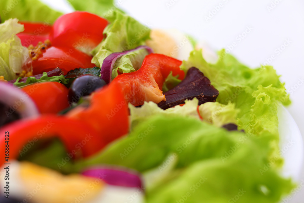 salad from fresh vegetables in a plate on a table, selective focus salad from fresh vegetables in a plate on a table, selective focus