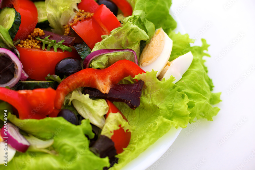 salad from fresh vegetables in a plate on a table, selective focus salad from fresh vegetables in a plate on a table, selective focus