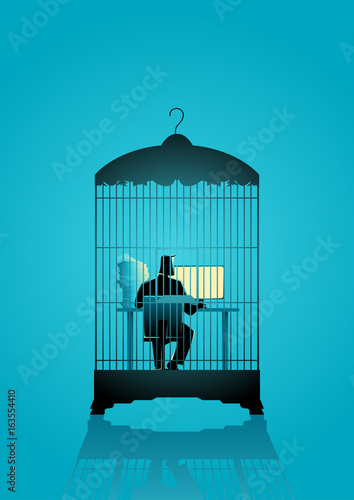 Businessman working on computer in the bird cage