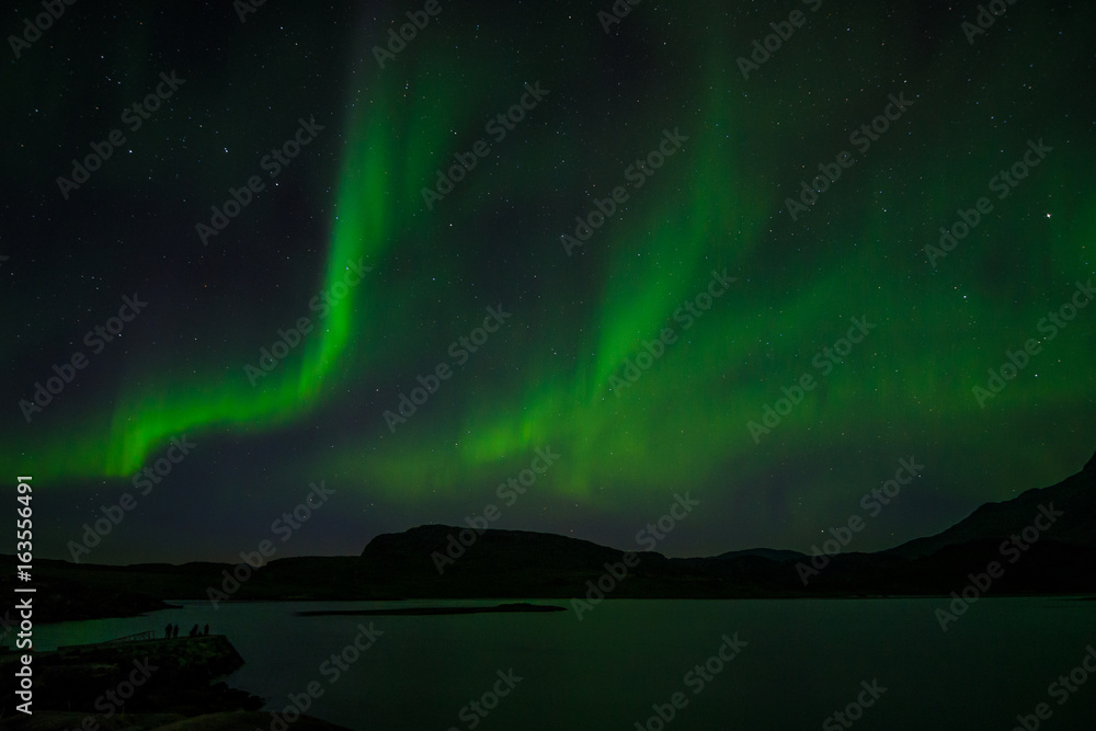 Northern lights at night over a lake