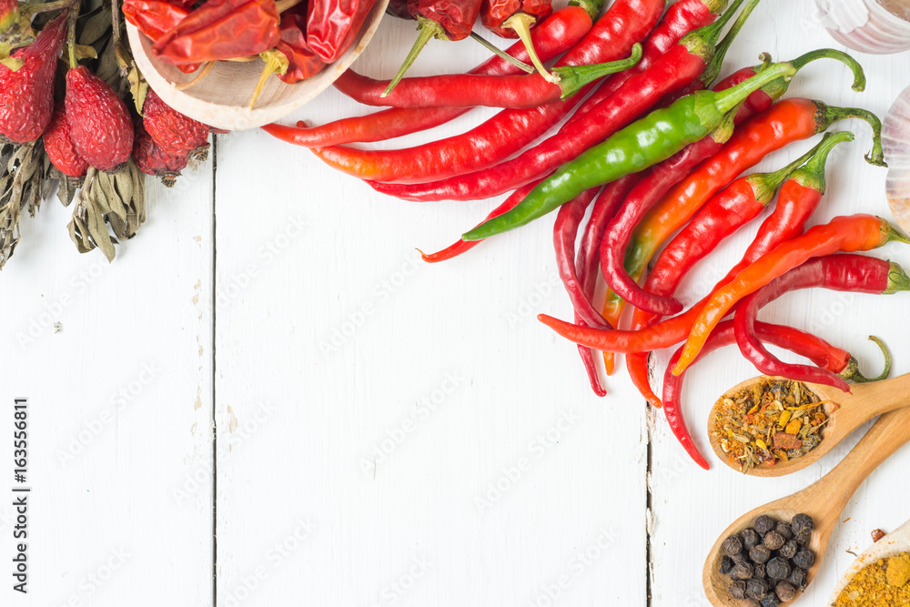 fresh chilli peppers, various kinds on white, space for advertising text, selective focus 