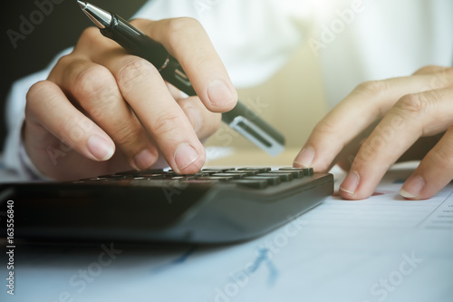 Εκτύπωση καμβά Close up asian Business man using a calculator to calculate the numbers