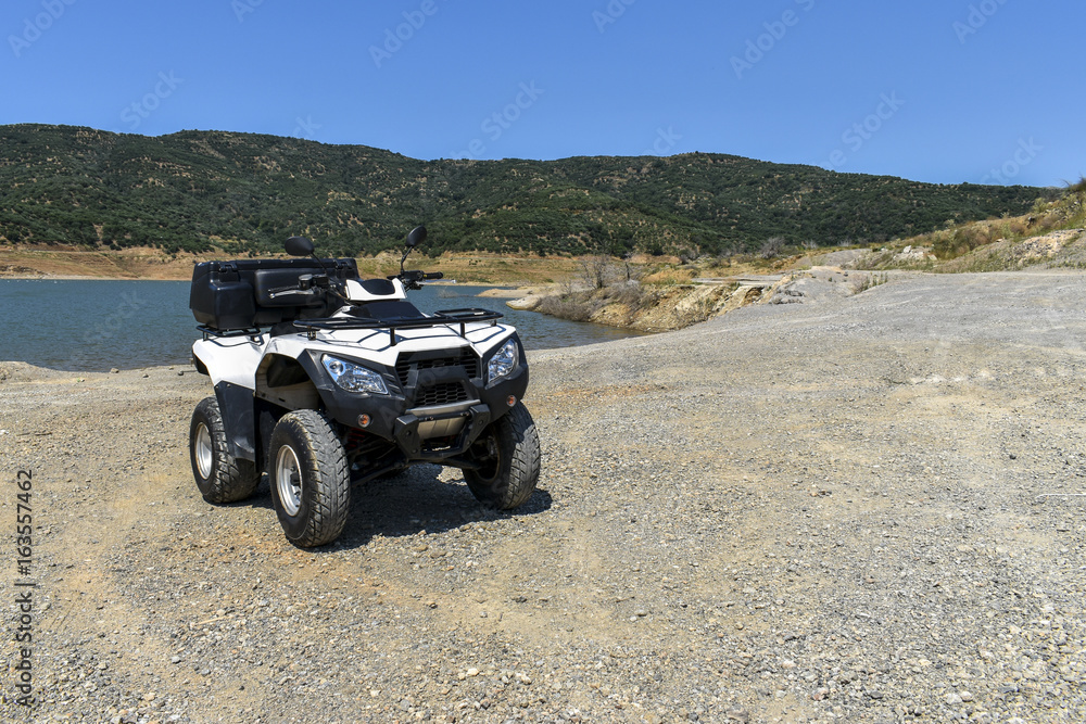 ATV offroad on mountain and sky background. ATV offroad on mountain and sky background.