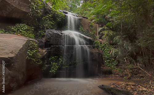 Hidden waterfall preserved well from modern development located deep in Tupah Recreational Park at Kedah northern state of Malaysia. soft focus blurry noise visible due to high ISO  Nature composition