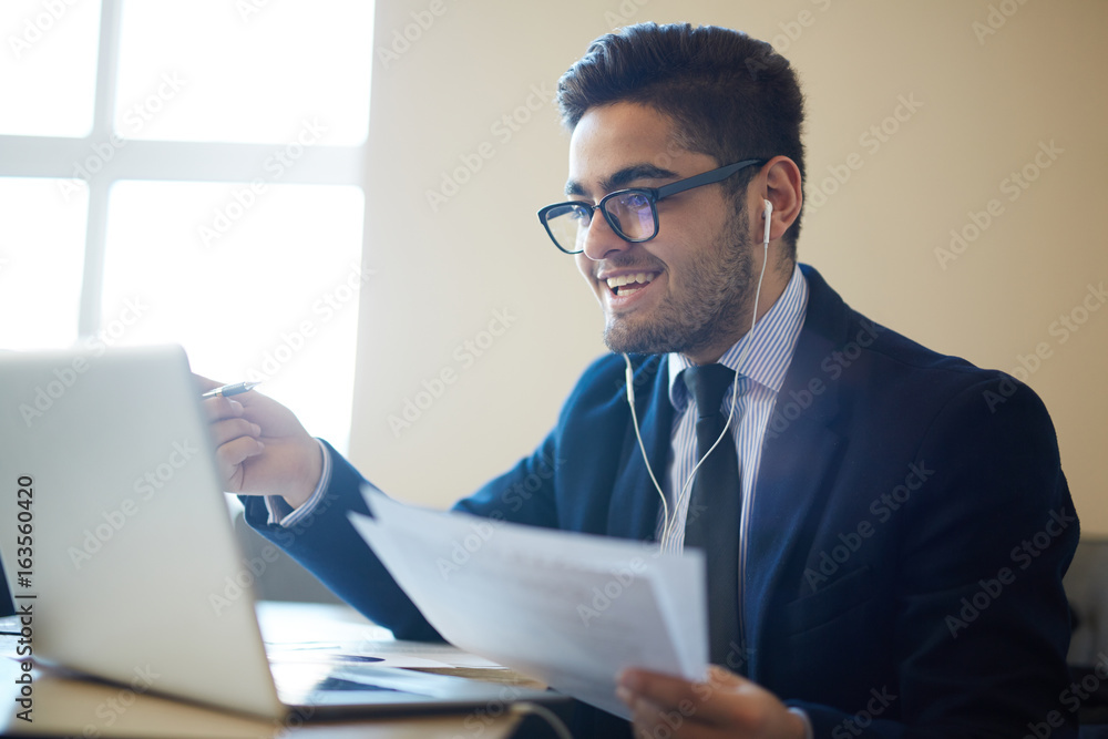 Happy trader with papers reading online information Happy trader with papers reading online information