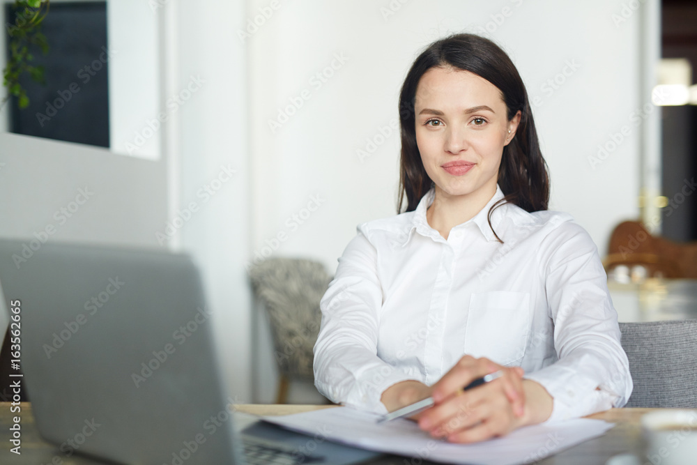 Young manager in white shirt looking at camera Young manager in white shirt looking at camera