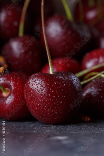 Juicy red cherry on a dark background.