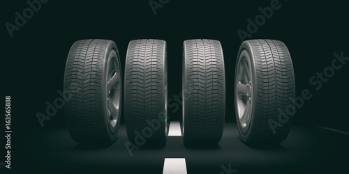 Car tires and rims on black background. 3d illustration