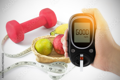Thumbs up, glucometer and fresh fruits with tape measure in background, concept for slimming, healthy nutrition and strengthening immunity,good and healty concept