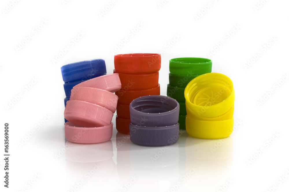Stacks of plastic bottle caps on white background. Still-life picture taken in studio with soft-box. Stacks of plastic bottle caps on white background. Still-life picture taken in studio with soft-box.