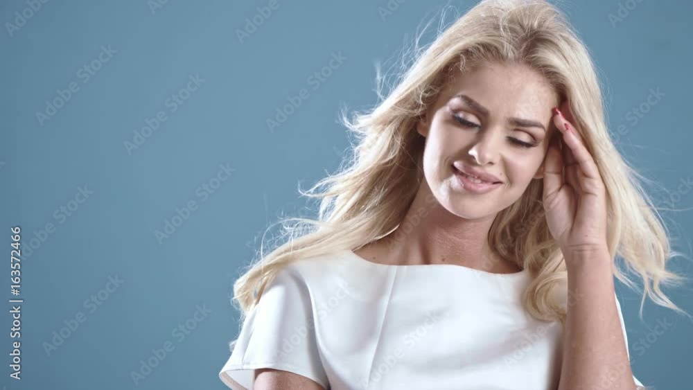 Elegant blond woman posing on a bright background, 4k slow motion clip Elegant blond woman posing on a bright background, 4k slow motion clip