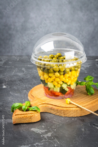 Healthy homemade salad in a jar with vegetables, cucumbers, tomatoes, peas and corn - Healthy diet, detox, pure food or vegetarian concept