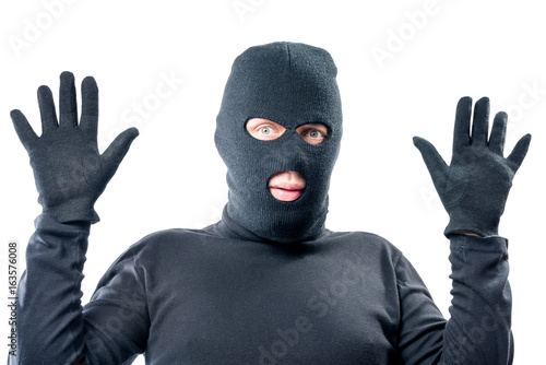 Bild auf Leinwand male robber held up his hands, in black clothes