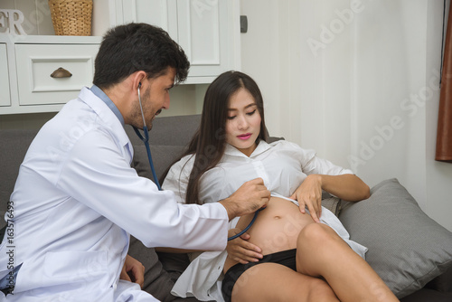 Doctor are Checking Pregnant Woman with Stethoscope in the Hospital - Health Care Concept