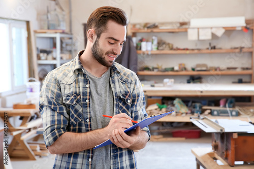 Handsome young carpenter in...