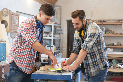 Carpenters applying marking...