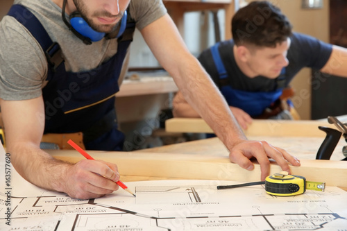 Two young carpenters workin...