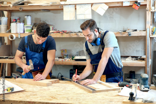 Young carpenters working in...