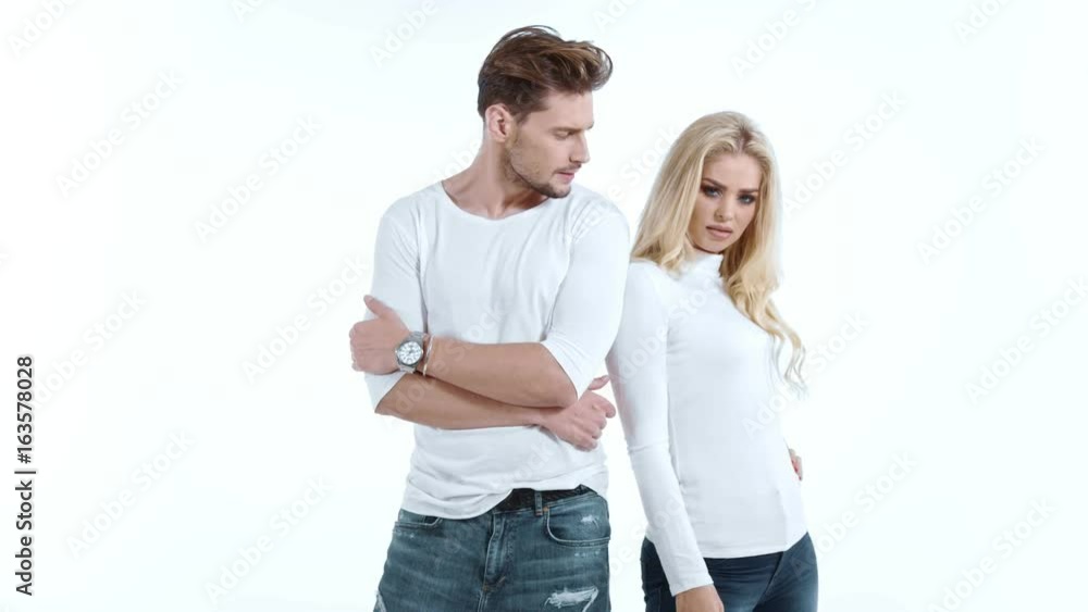 Sexy young couple posing on studio background, 4k slow motion studio clip Sexy young couple posing on studio background, 4k slow motion studio clip