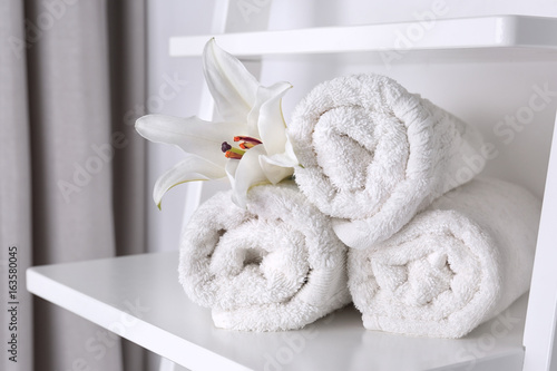 Clean white towels on shelf