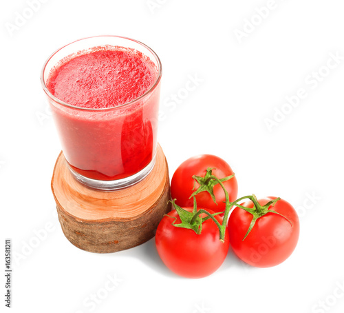 Glass of smoothie and fresh tomatoes on white background