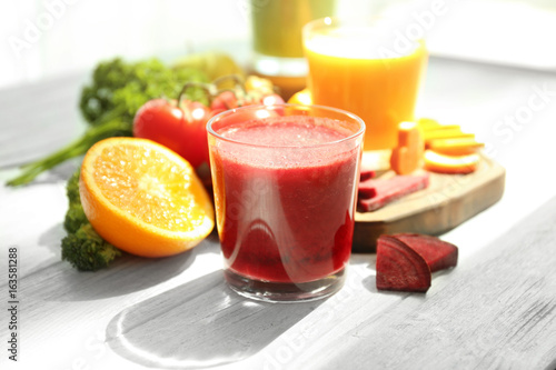 Fresh smoothies, vegetables and fruits on table