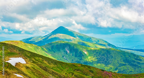 Panoramic view of the sky and mountain ridges from the top of the mountain in a sunny summer day © Yuriy Vahlenko