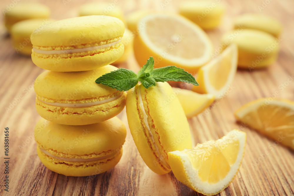 Tasty lemon macarons on wooden table, closeup Tasty lemon macarons on wooden table, closeup
