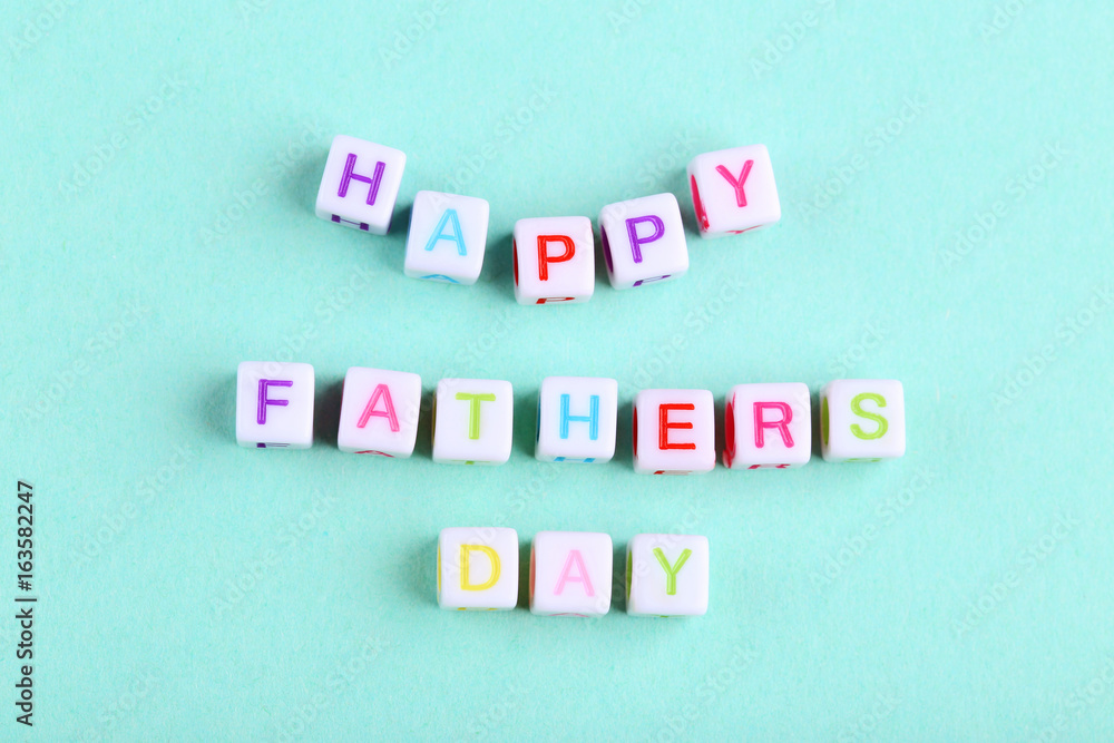 Happy fathers day written by cubes on mint background Happy fathers day written by cubes on mint background