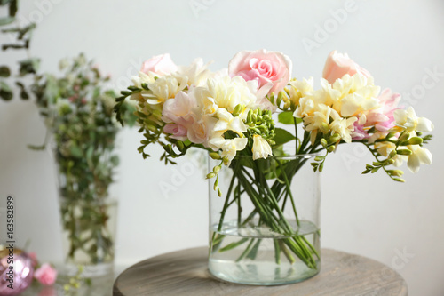Wallpaper Mural Beautiful bouquet with freesia flowers in glass vase on light background Torontodigital.ca