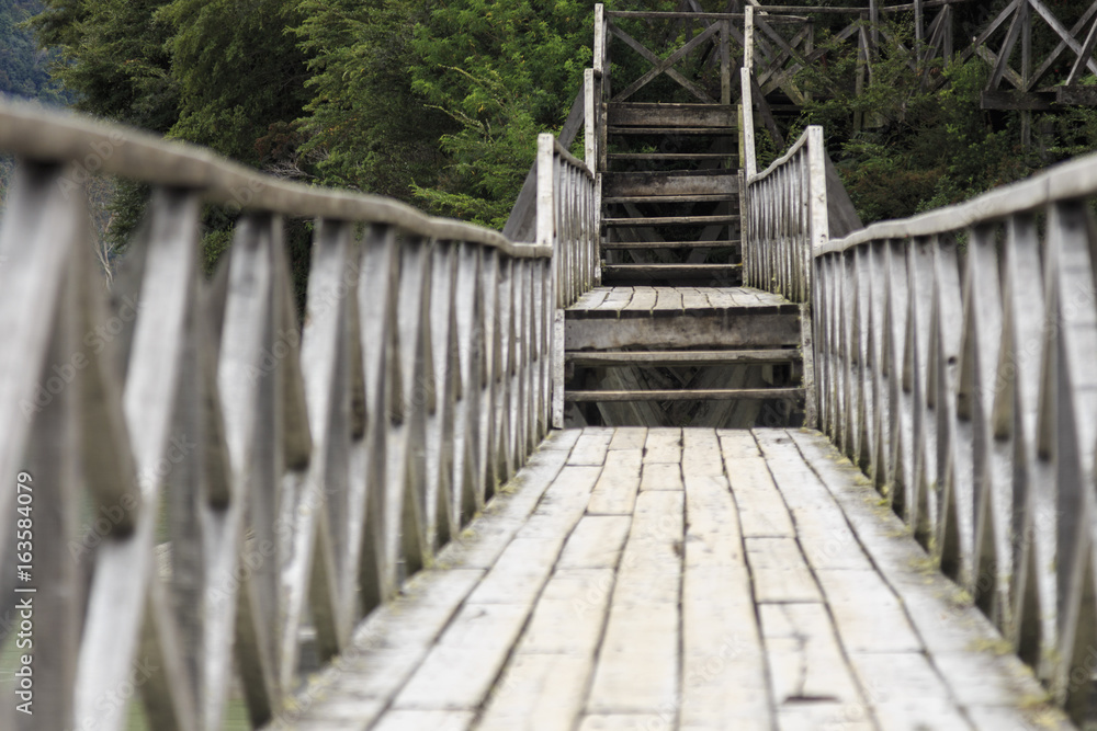 Typical wooden footbridge and stairs in Caleta Tortel