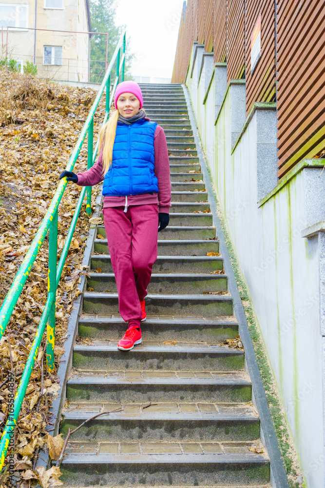 Woman wearing sportswear exercising outside during autumn Woman wearing sportswear exercising outside during autumn