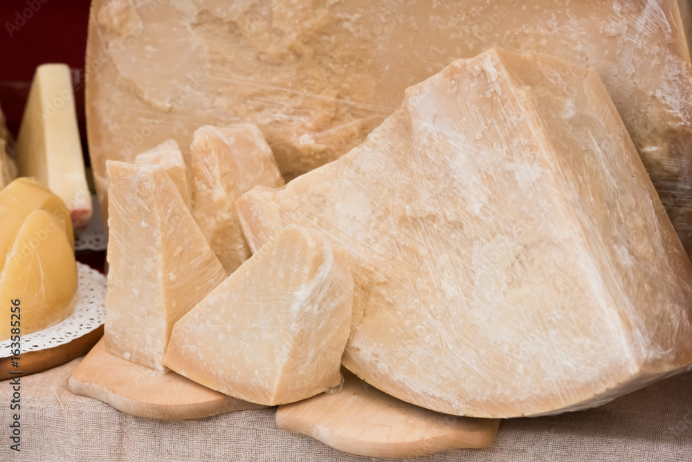 Chunk of Parmesan cheese at outdoor market Chunk of Parmesan cheese at outdoor market