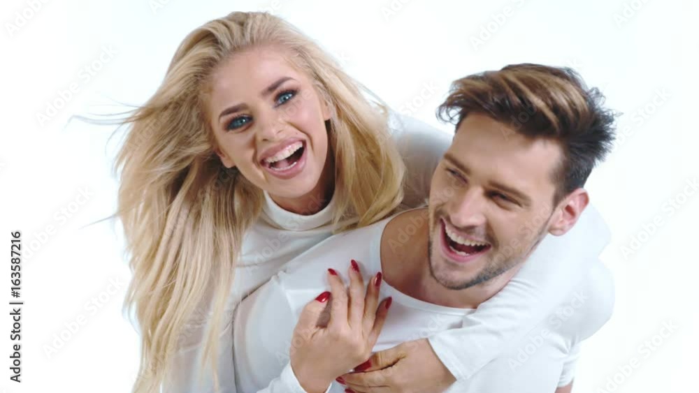 Sexy young couple posing on studio background, 4k slow motion studio clip Sexy young couple posing on studio background, 4k slow motion studio clip