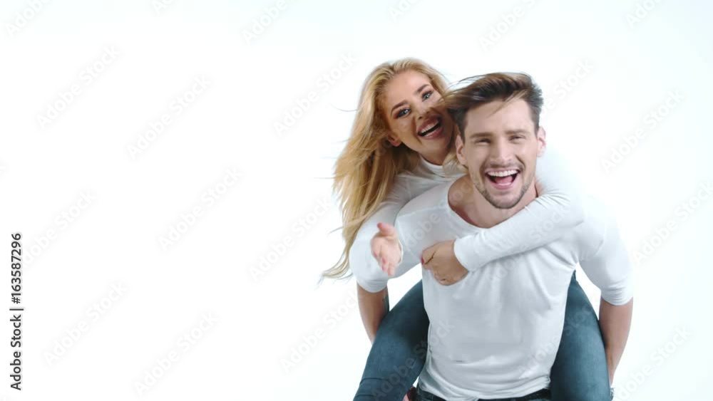 Sexy young couple posing on studio background, 4k slow motion studio clip Sexy young couple posing on studio background, 4k slow motion studio clip